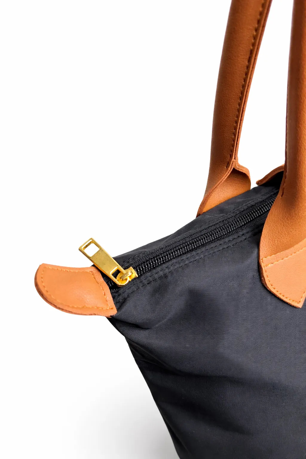 Black bag with brown leather handles and zipper on a white background
#color_black