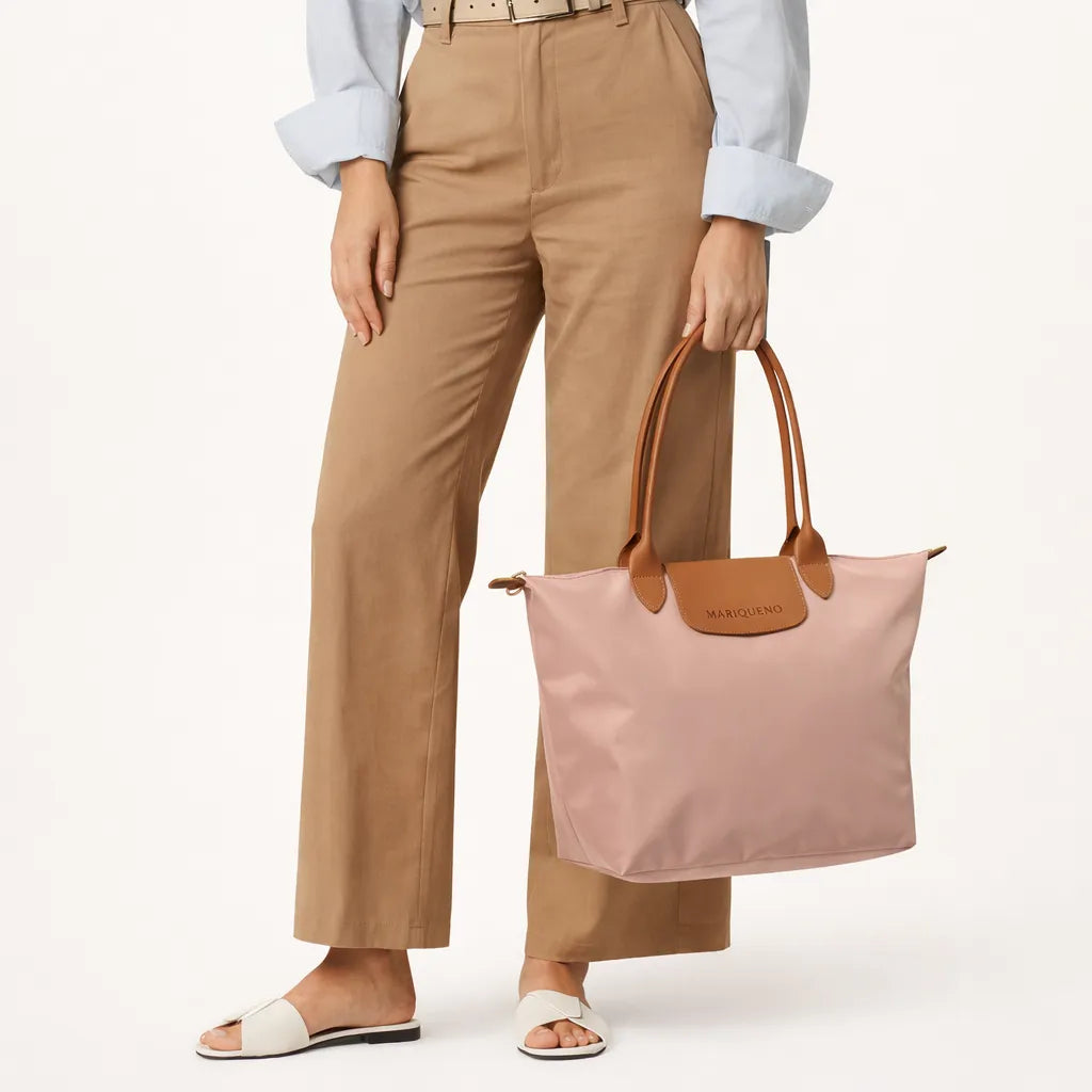 Person holding a taupe tote bag with brown handles on a white background
#color_taupe