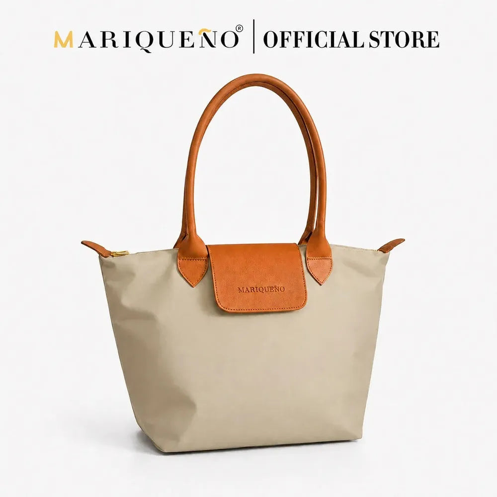 Taupe handbag with brown handles and accents on a white background, featuring the Mariqueno logo.
#color_taupe