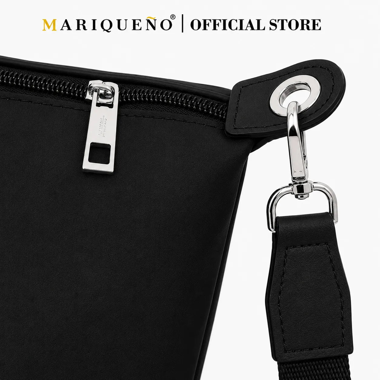 Black bag with zipper and strap detail, featuring Mariqueno brand.
#color_black