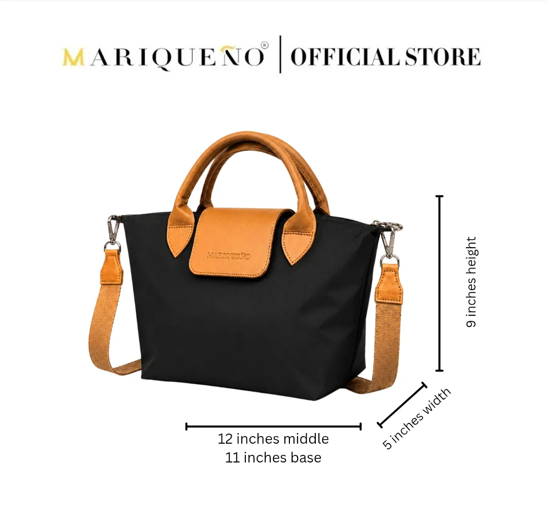Black handbag with orange handles and strap, featuring Mariqueno branding, on a white background.
#color_black and tan