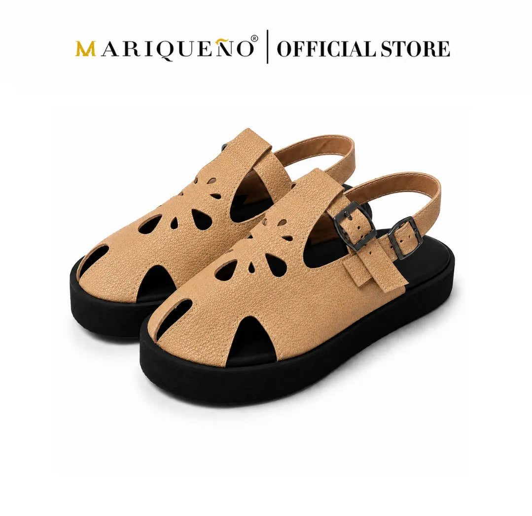 A pair of women's pebbled leather sandals in tan with black soles and cutout details, displayed on a white background with 'MARIQUENO | OFFICIAL STORE' text at the top.
#color_beige