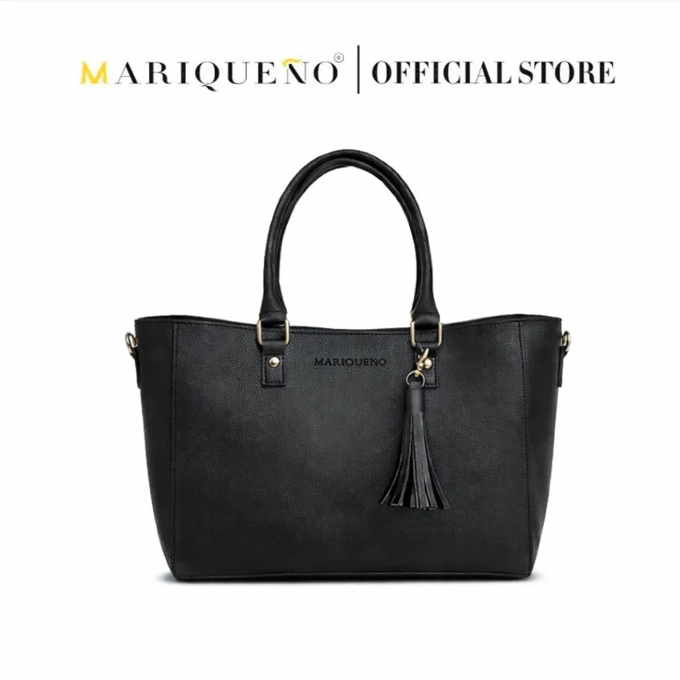 Black handbag with tassel detail on a white background, featuring the Mariqueno brand.
#color_black