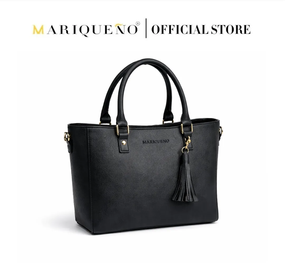Black handbag with tassel detail on a white background, featuring the Mariqueño brand.
#color_black
