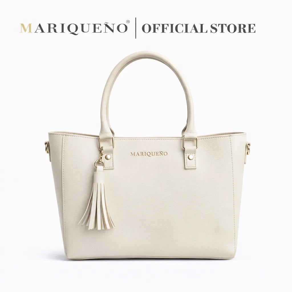 Offwhite handbag with tassel detail and 'Mariqueno' branding on a white background
#color_off white