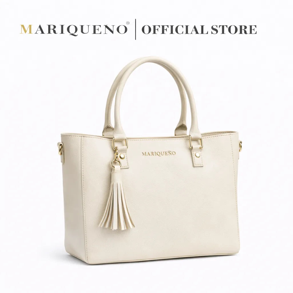 Beige handbag with tassel detail and 'Mariqueno' branding on a white background
#color_off white