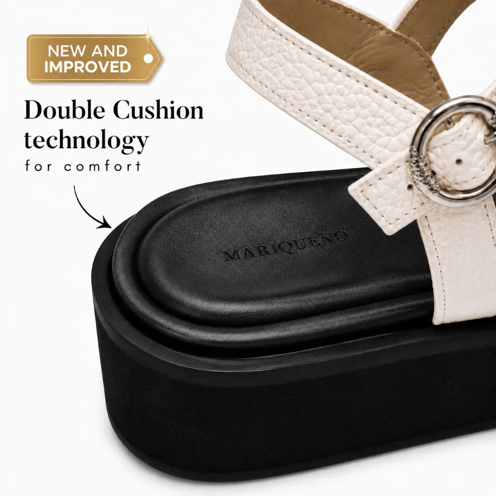 A close-up of a Mariqueno platform sandal with a black double-cushion sole and a cream-colored textured strap with a silver buckle, featuring text overlay 'Double Cushion technology for comfort'.
#color_white