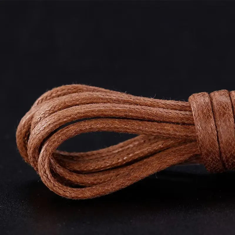 Close-up of brown leather shoelaces on a black background
#color_walnut