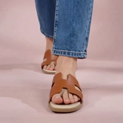A woman wearing tan h-shaped flats
#color_tan